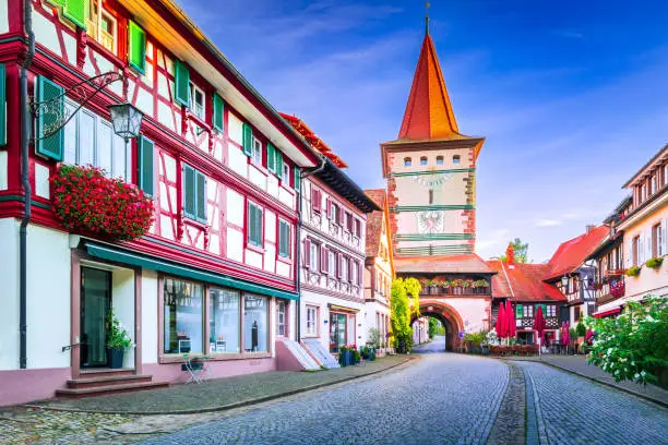 Gengenbach, Germany. Charming city in Black Forest with Obertorturm tower and colorful timber-framed house decorated with flowers.