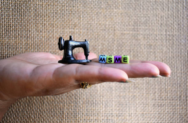 Small scale business concept with hand holding sewing machine having MSME approach.