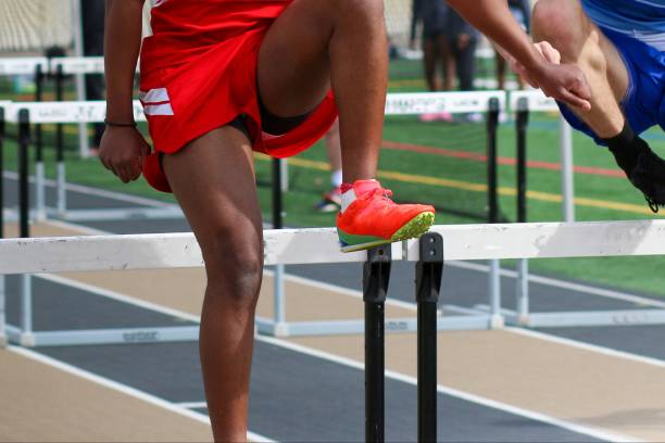 Boys running during a hurdle race on a track