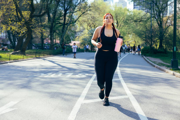 istock Woman jogging in Central Park 1486803006