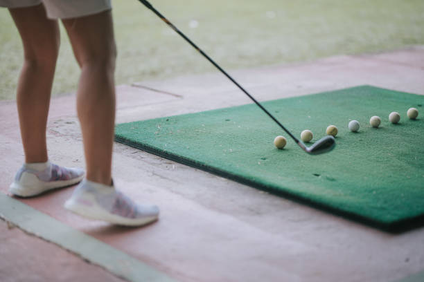 istock low section asian chinese female golfer practicing golf swing at driving range 1486805996