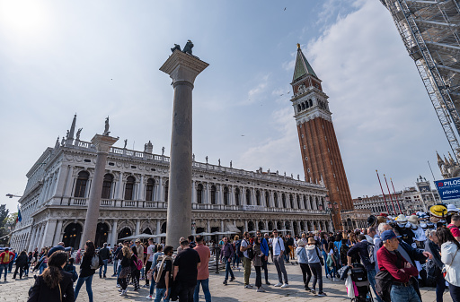 Venice, Italy - April 22, 2023: St. Mark's Campanile is the bell tower pertaining to St. Mark's basilica. The bell tower collapsed in 1902 and was reconstructed in 1912.