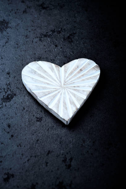istock Wooden Heart on dark stone background. Soft focus. Copy space. 1486811296