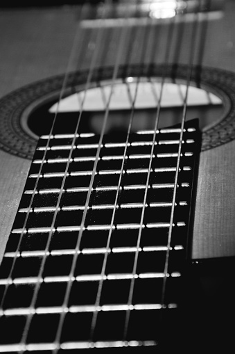 Black and white photo of the guitar, close-up of the strings