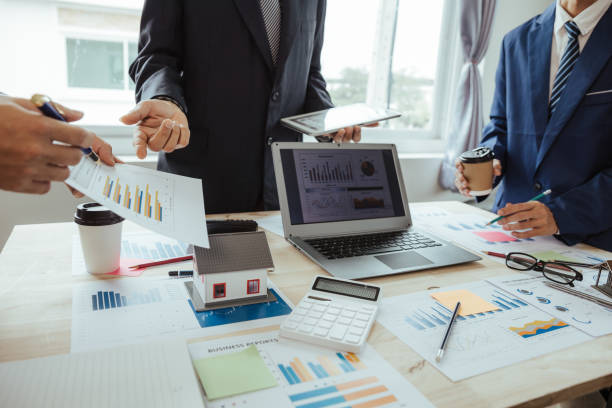 istock Teamwork with businessmen analyzing cost graphs on table at conference room. 1486813291