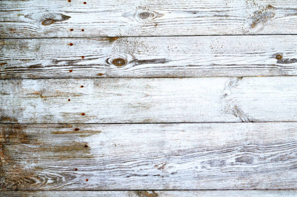 istock Cracked weathered gray shabby chic painted wooden board texture, front view 1486814175