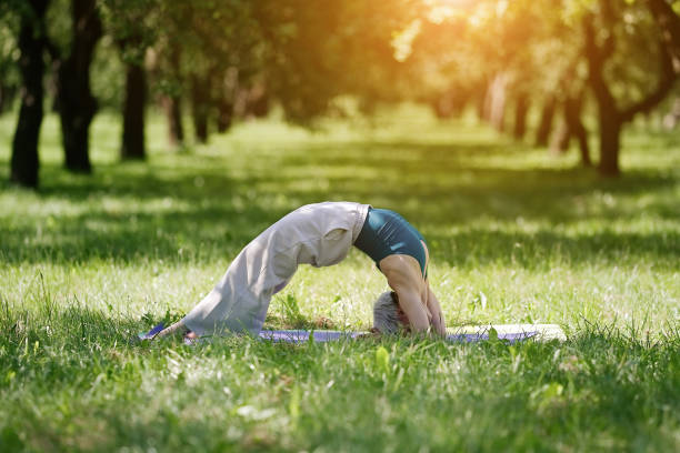 istock Young woman doing yoga exercise 1486814971