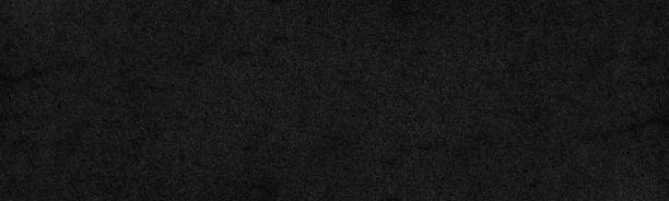 Black rough surface distressed texture. Dark wall gloomy grunge panoramic textured background