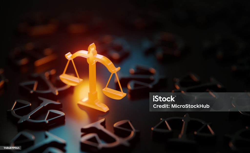 Orange Scale Symbol Glowing Amid Black Scale Symbols On Black Background Orange scale symbol glowing amid black scale symbols on black background. Horizontal composition with copy space. Justice concept. Legal System Stock Photo