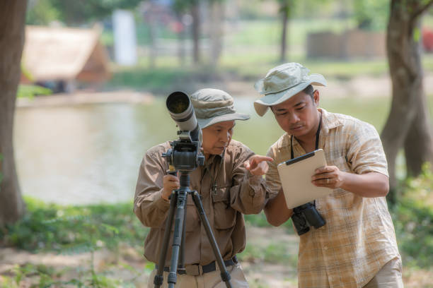 istock Two Retired Male Friends On Walking Holiday Looking Through Binoculars 1486820863