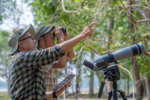 istock Two Retired Male Friends On Walking Holiday Looking Through Binoculars 1486820874