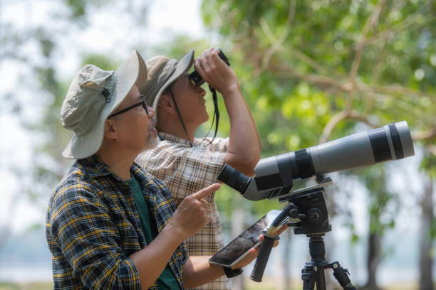 istock Two Retired Male Friends On Walking Holiday Looking Through Binoculars 1486820891