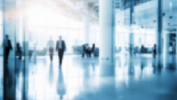 istock Business people walking in office, blurry working space with defocused effect, blurred motion business background 1486821245