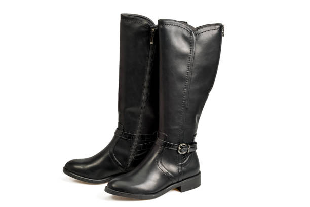 istock Beautiful view of black leather knee-high boots isolated on white background. 1486826464