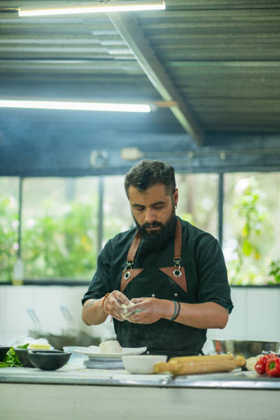 istock Chef cooking from his vegan restaurant while wearing his uniform 1486827246