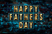 Happy Father's Day background. Letterings from rusty, iron letters on an old grunge brick wall. Holidays.