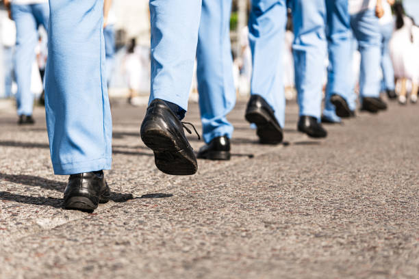 istock Feet of uniformed men marching in a parade. 1486832870