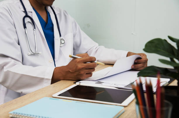istock Smart medicine doctor working with computer notebook and digital tablet at desk in the hospital. Medical concept 1486834419