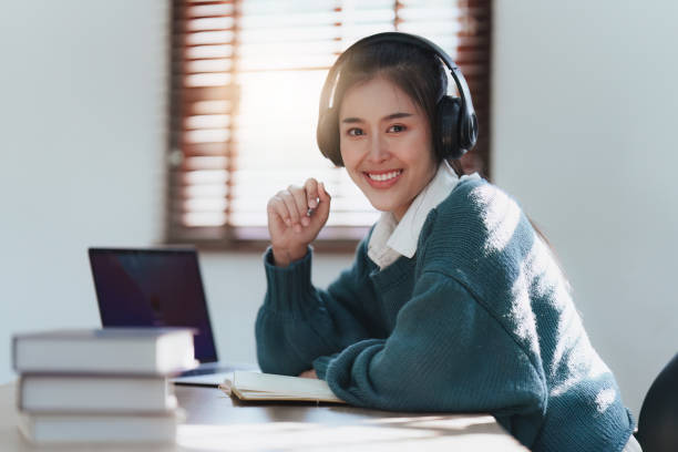 istock E-learning ,online ,education and internet social distancing. Asian woman student video conference e-learning with teacher on laptop computer at home. 1486836038
