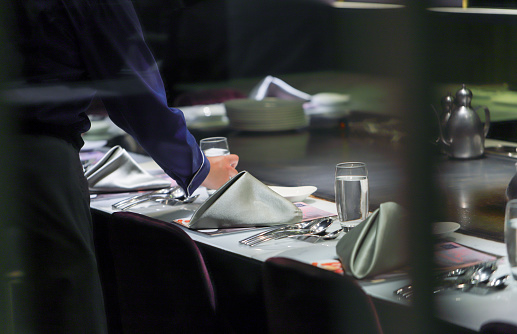 Intimate atmosphere in a restaurant with four served plates - beef steak, chicken, fish and appetizer