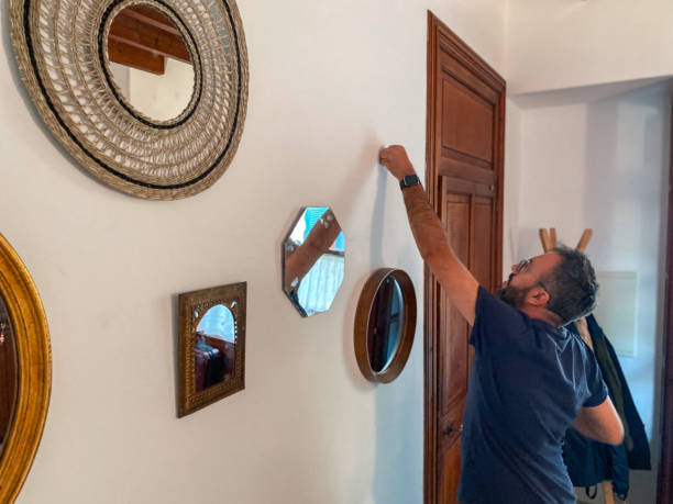 istock Man hanging mirrors in the hall at home 1486837034
