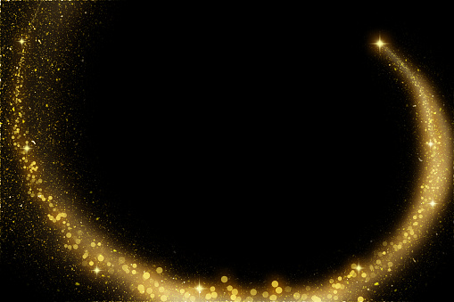 Gold sparkles and glitter on black background. Abstract defocused lights and bokeh on dark background