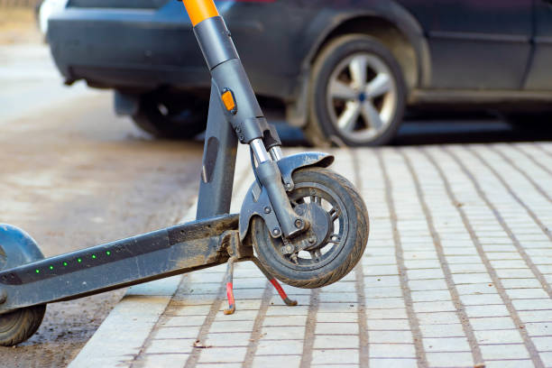 istock a scooter left on the sidewalk incorrectly after a ride. parking and traffic violations. part of the vehicle 1486841802