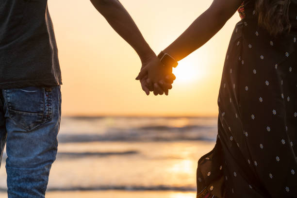 istock Couple Appreciation Day concept image, lovers on the beach during sunset 1486844519