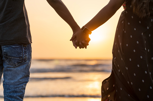 Couple Appreciation Day concept image, lovers on the beach during sunset, Couple hold hands image, valentines day background