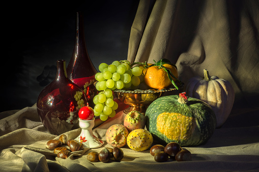 composition with grapes pumpkin prickly pears mandarin in Caravaggio light