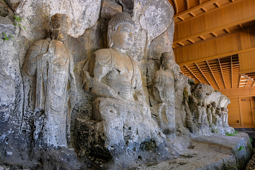 Usuki, Japan - May 1, 2023: The Usuki Stone Buddhas are a set of sculptures carved into rock during the 12th century in Usuki, Japan.