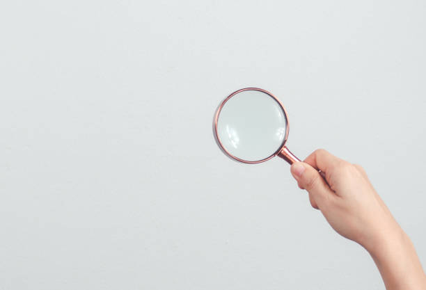 istock Businessman hand use magnifying glass Search On Virtual Screen Data Search Technology Search Engine Optimization. Searching for information. 1486847283