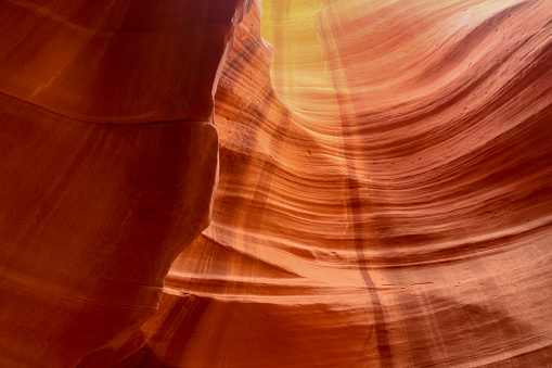 The sandstone absorbs the sunlight creating golden orange colors on the walls eroded by time in the Upper Antelope Canyon located at the Navajo National Monument, Parks and Recreation near Page Arizona.
