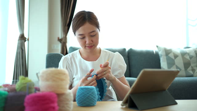 Woman making a crochet craft.