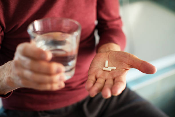 istock Senior man taking a pill in a bathroom 1486853573