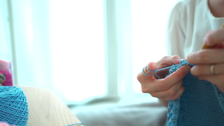 Woman making a crochet craft.