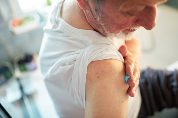 istock Senior man putting medical cream on his shoulder 1486854371