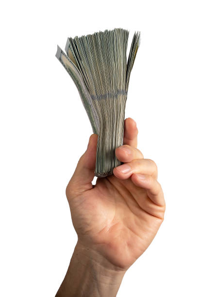 istock Hand holding dollar bills stack, money, bank notes, us banknotes isolated on white background 1486857542
