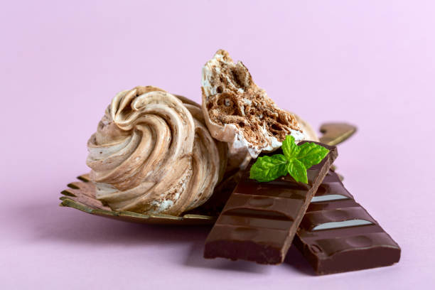 istock Meringues with dark chocolate close up. 1486864032