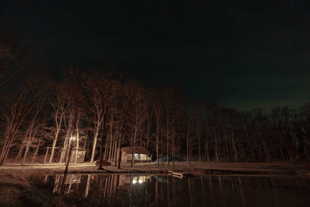 An AirBnB cabin in the middle of the woods with a dock and pond