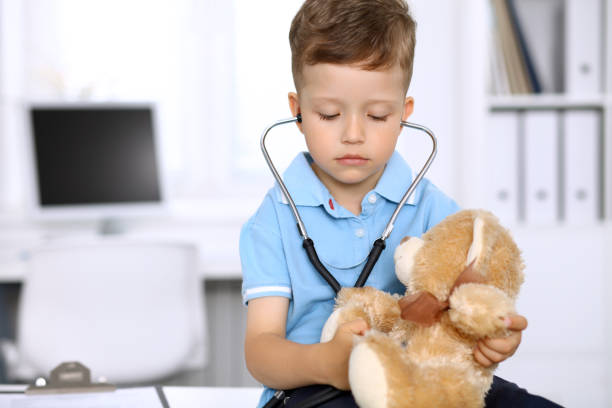 istock Little doctor examining a 
toy bear  patient by stethoscope 1486868052