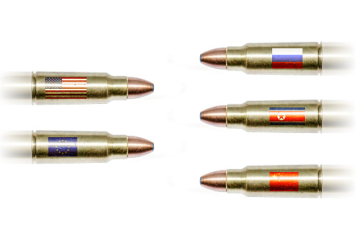 Bullets with flags (USA, EU, Russia, China and North Korea) flying towards each other on white background. This is to show the geopolitical tension there is currently between countries.