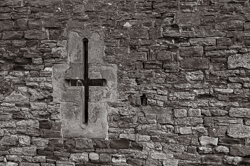 An old section of wall with an arrow slit