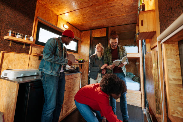 istock Stylish friends activities in caravan cabin. 1486870367