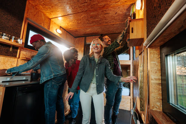 istock Happy friends in camper trailer. 1486870632