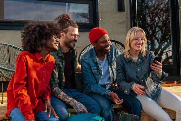 istock Cheerful people using mobile phone outdoors. 1486870719
