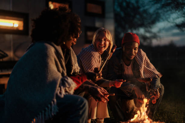 istock Cheerful friends barbecue at campfire. 1486872576