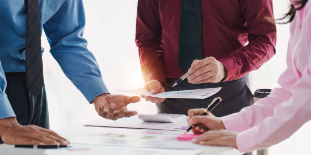 istock Group of Businessman or Accountant checking finance data document for investigation of corruption account. Anti Bribery concept 1486872665