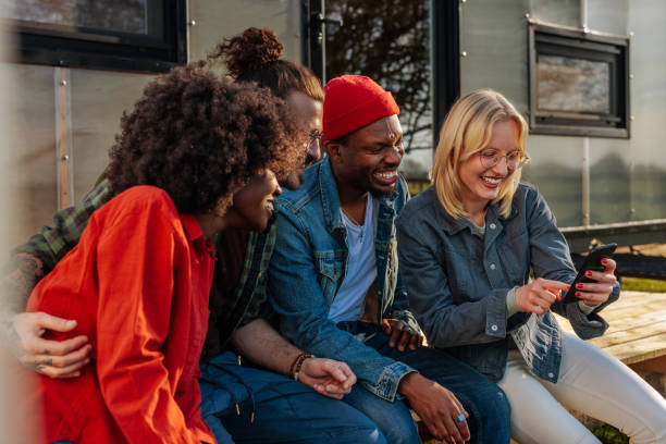 istock Cheerful friends using cellphone outdoors. 1486872958