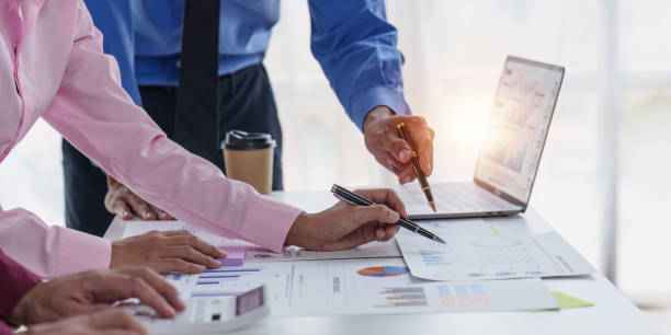 istock Group of Businessman or Accountant checking finance data document for investigation of corruption account. Anti Bribery concept 1486873518